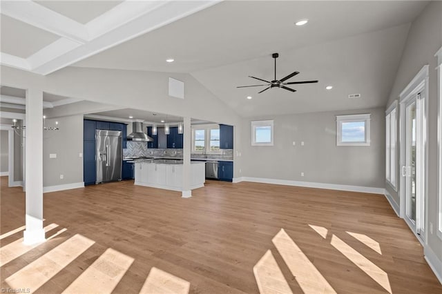 unfurnished living room featuring visible vents, baseboards, a ceiling fan, light wood-style floors, and vaulted ceiling