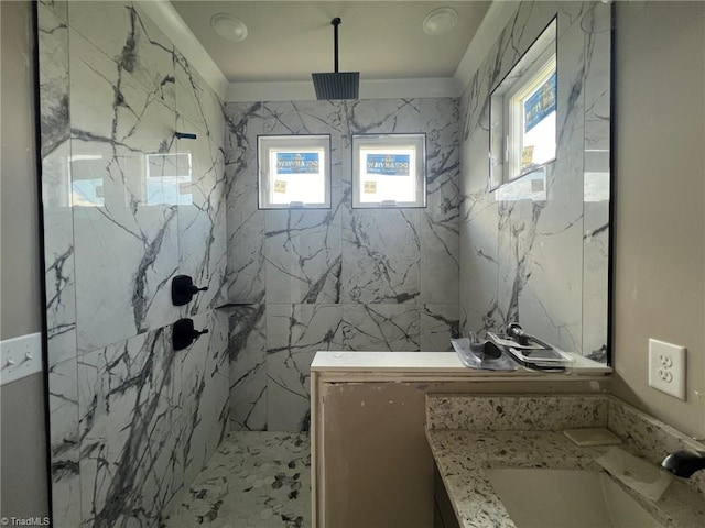 bathroom with vanity, a healthy amount of sunlight, and a tile shower