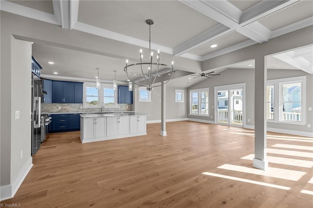 kitchen featuring high end fridge, recessed lighting, open floor plan, light countertops, and blue cabinetry