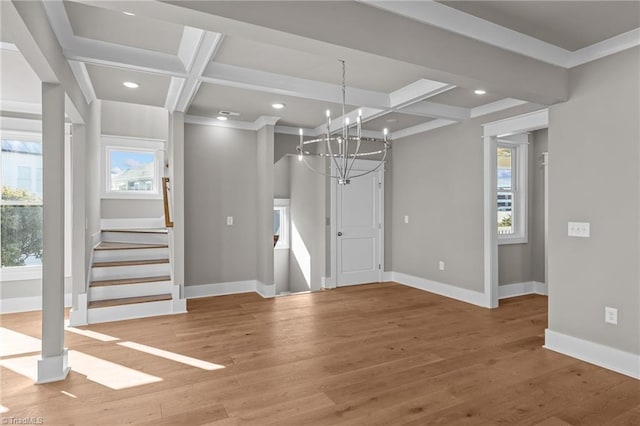 interior space with beamed ceiling, baseboards, coffered ceiling, and a notable chandelier