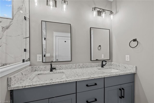 bathroom featuring a sink and double vanity