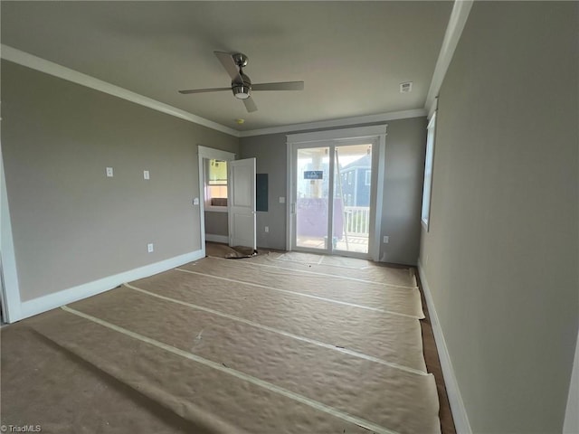 unfurnished room featuring ceiling fan and crown molding