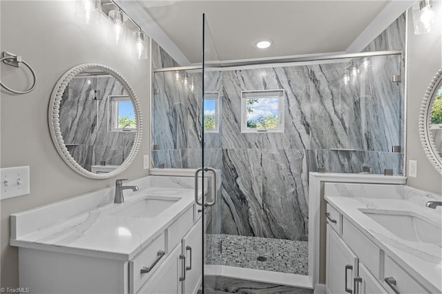 bathroom with a marble finish shower and a sink