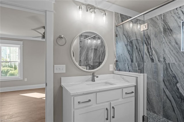 bathroom featuring vanity, a ceiling fan, a marble finish shower, and wood finished floors