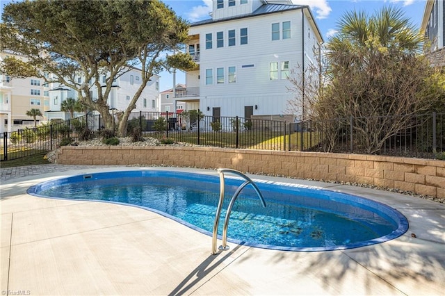 view of swimming pool with a residential view, a fenced in pool, and fence