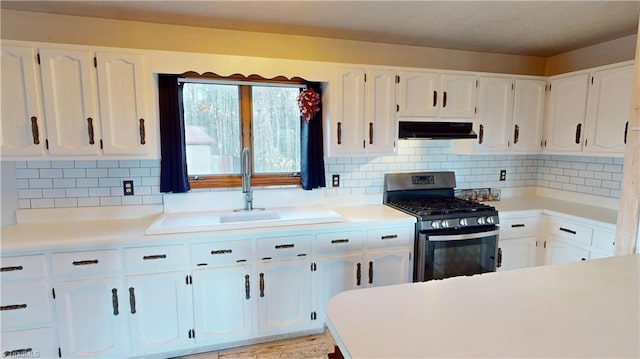 kitchen featuring backsplash, white cabinets, and stainless steel range with gas stovetop