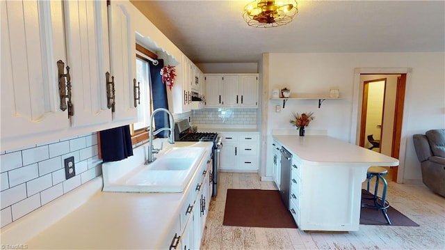 kitchen featuring a kitchen bar, white cabinetry, tasteful backsplash, and light hardwood / wood-style floors