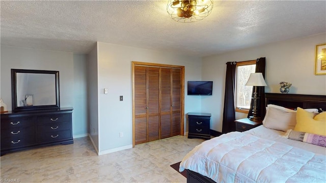 bedroom with a closet and a textured ceiling