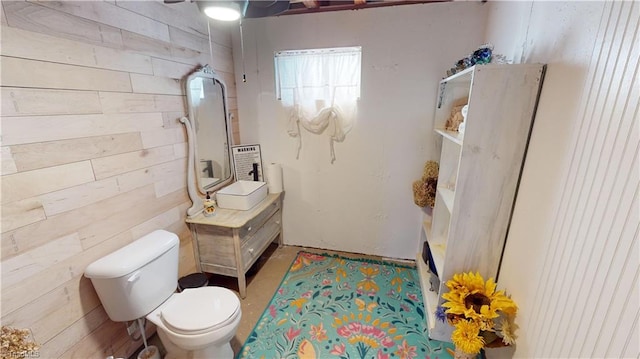 bathroom with a washtub, vanity, and toilet