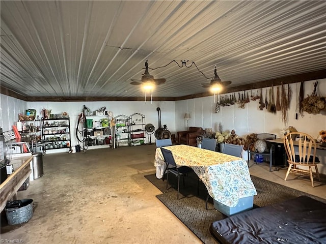 interior space with ceiling fan and concrete floors