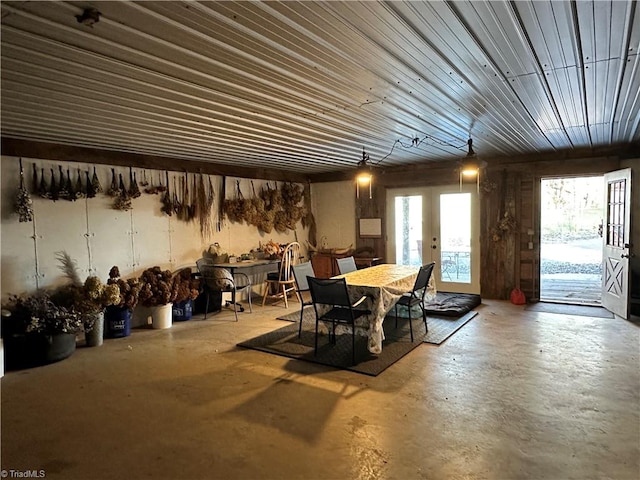 dining room featuring french doors and concrete floors