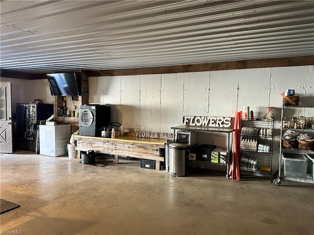 garage featuring a workshop area and washer / clothes dryer