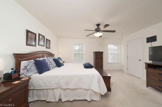 bedroom featuring light colored carpet and a ceiling fan