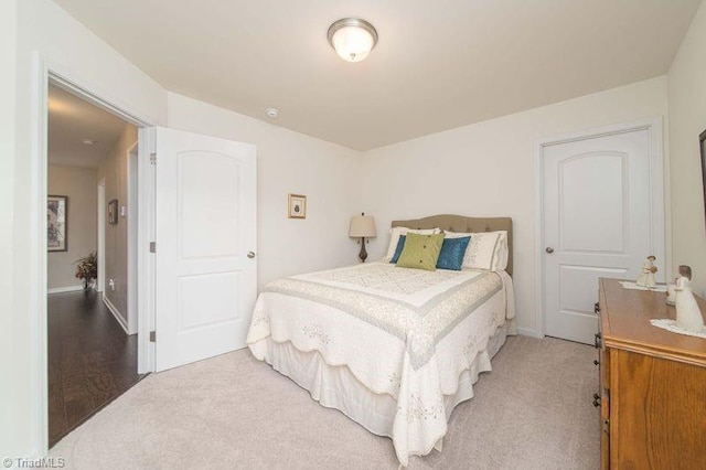 bedroom featuring carpet and baseboards