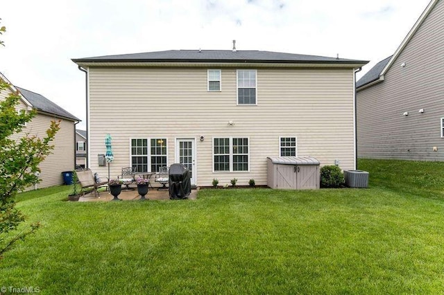 back of property with a patio area, a lawn, and cooling unit