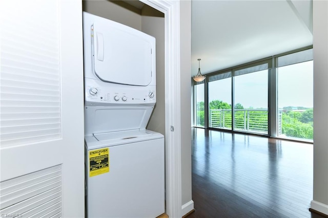 201 N Elm St Unit 310, Greensboro, NC 27401 - laundry room featuring estacked washer and dryer and dark wood-style flooring