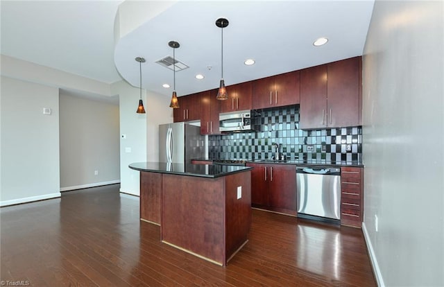 201 N Elm St Unit 310, Greensboro, NC 27401 - kitchen with stainless steel appliances, dark countertops, a kitchen island, dark wood-style floors, and backsplash