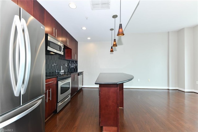 201 N Elm St Unit 310, Greensboro, NC 27401 - kitchen featuring appliances with stainless steel finishes, dark countertops, dark wood-type flooring, recessed lighting, and backsplash