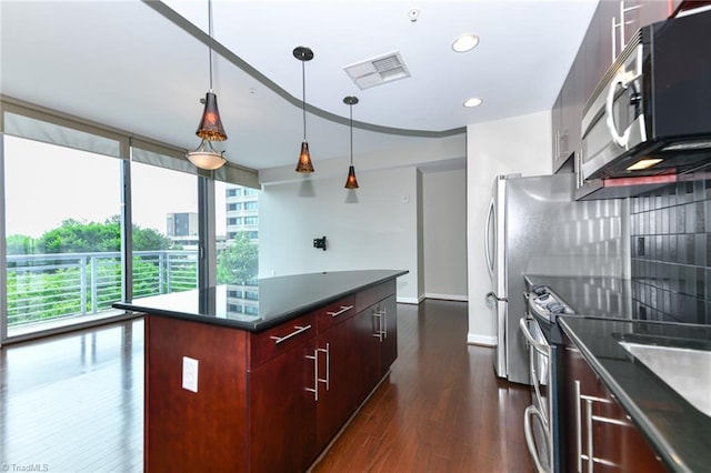 201 N Elm St Unit 310, Greensboro, NC 27401 - kitchen with stainless steel appliances, dark countertops, modern cabinets, dark wood-style flooring, and recessed lighting