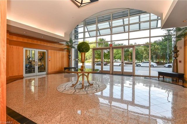 201 N Elm St Unit 310, Greensboro, NC 27401 - community lobby featuring a high ceiling, wood walls, and a wall of windows