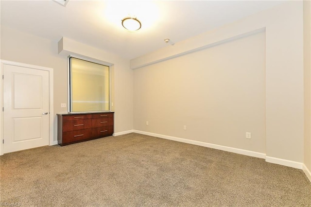 201 N Elm St Unit 310, Greensboro, NC 27401 - unfurnished bedroom with carpet flooring and baseboards
