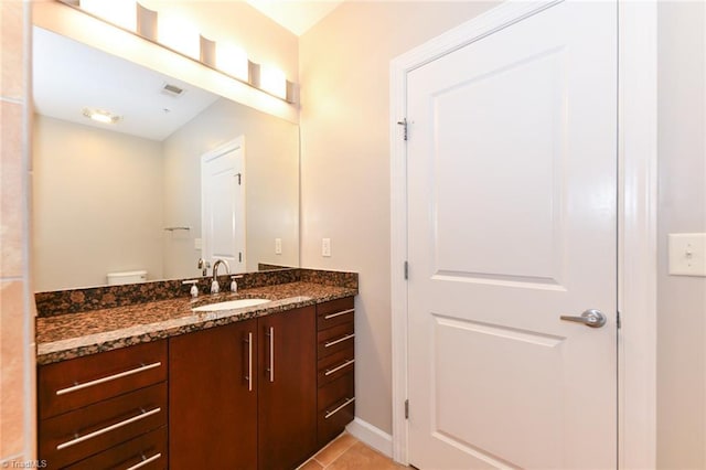 201 N Elm St Unit 310, Greensboro, NC 27401 - bathroom featuring vanity, tile patterned floors, baseboards, and toilet