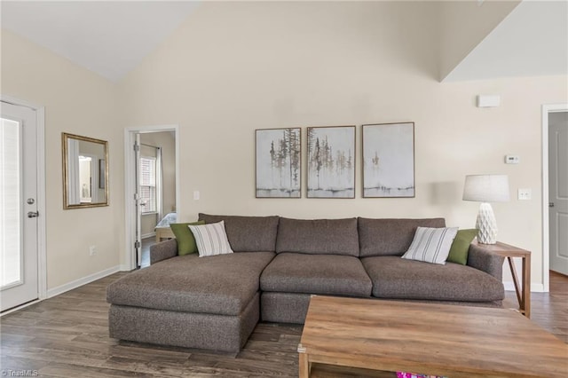 living room featuring baseboards, high vaulted ceiling, and wood finished floors