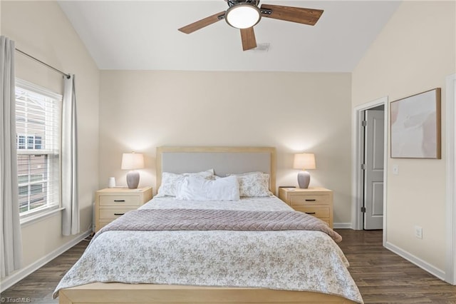 bedroom with multiple windows, dark wood-type flooring, and vaulted ceiling