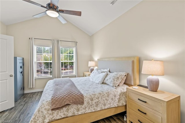 bedroom featuring lofted ceiling, visible vents, dark wood finished floors, a ceiling fan, and baseboards