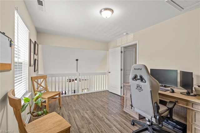 home office featuring visible vents and wood finished floors