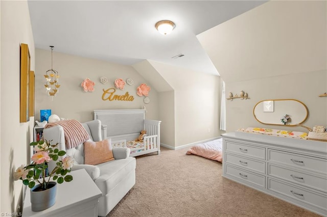 bedroom featuring lofted ceiling, light carpet, visible vents, and a nursery area