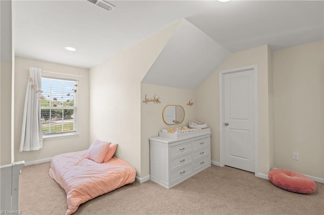 bedroom with baseboards, light carpet, visible vents, and vaulted ceiling