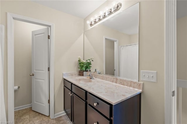 full bath featuring vanity and baseboards
