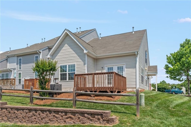 back of house featuring a yard, roof with shingles, fence, and a wooden deck