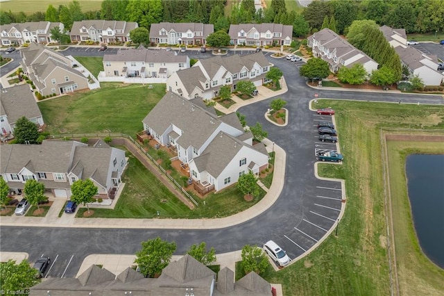 birds eye view of property with a water view and a residential view
