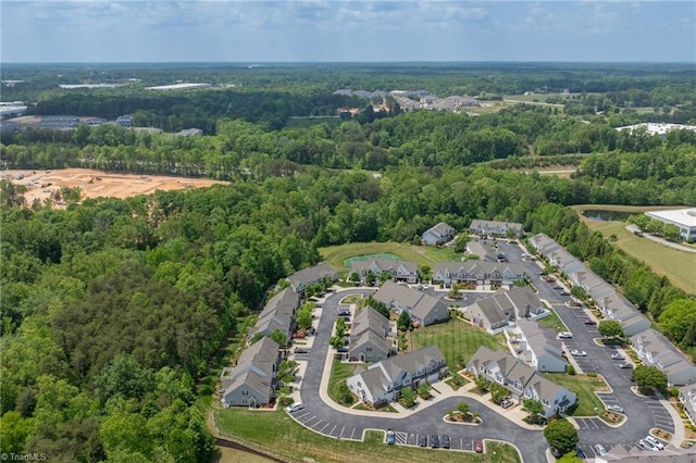 birds eye view of property with a forest view and a residential view