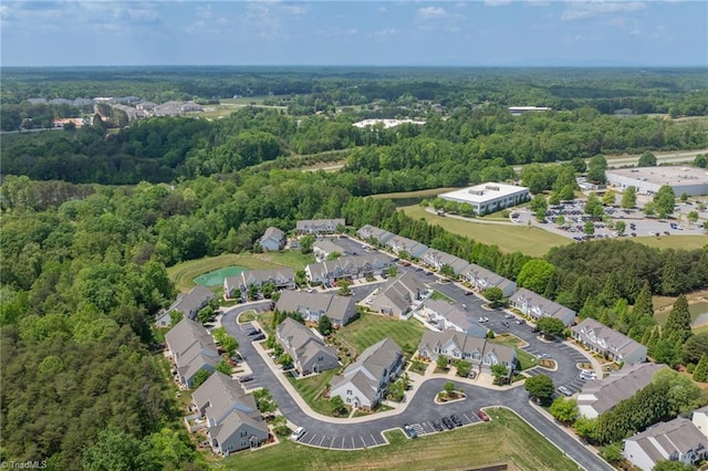 bird's eye view featuring a forest view and a residential view