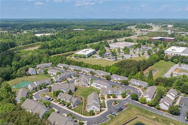 drone / aerial view featuring a wooded view