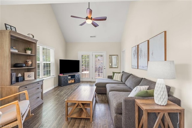 living area featuring high vaulted ceiling, dark wood-type flooring, baseboards, visible vents, and ceiling fan