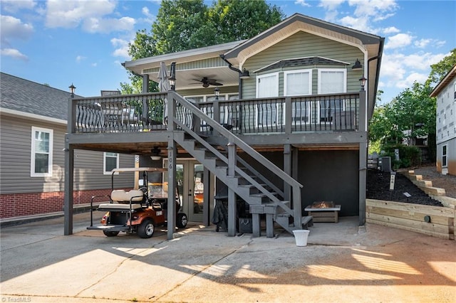 back of property featuring stairs, a fire pit, ceiling fan, a carport, and central AC