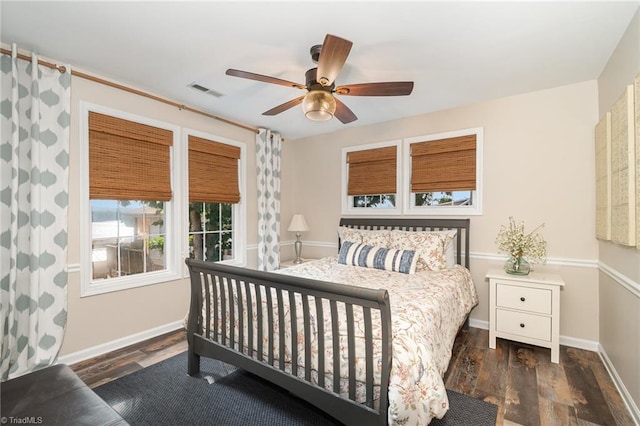 bedroom featuring wood finished floors, baseboards, and a ceiling fan