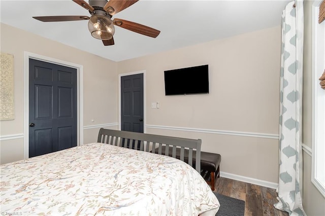 bedroom with wood finished floors, baseboards, and a ceiling fan