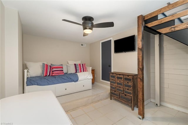 bedroom with a ceiling fan and light tile patterned floors