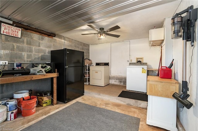 miscellaneous room with separate washer and dryer, a ceiling fan, unfinished concrete floors, and concrete block wall