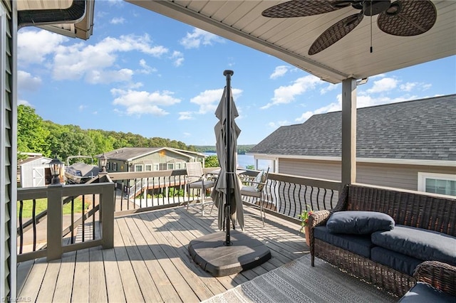 wooden terrace featuring a ceiling fan and a residential view