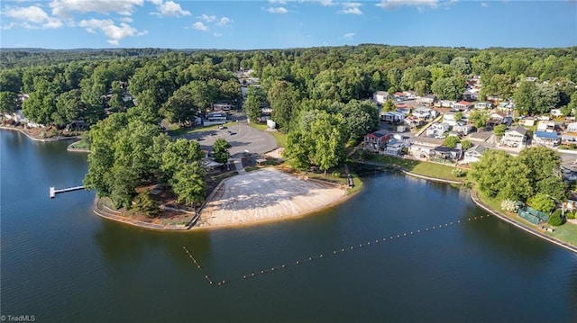 aerial overview of property's location featuring a heavily wooded area and a large body of water