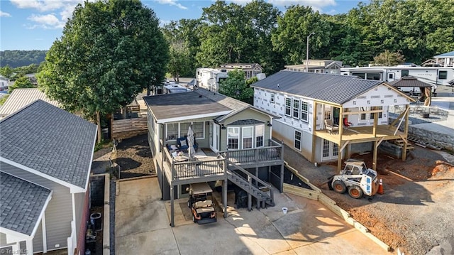 back of house featuring a wooden deck, stairs, and a patio