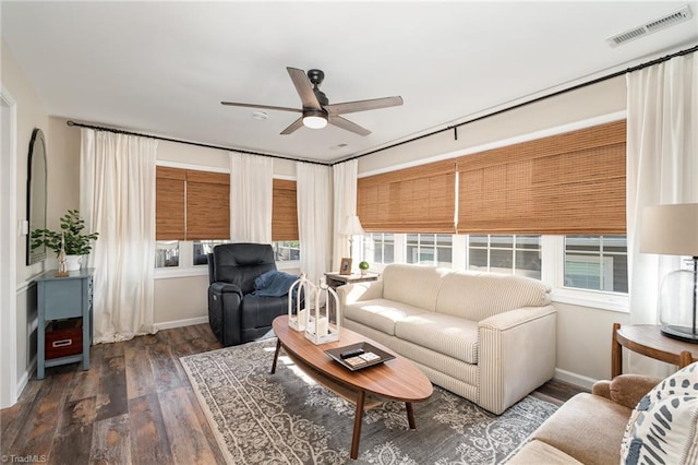 living area featuring ceiling fan, plenty of natural light, and wood finished floors