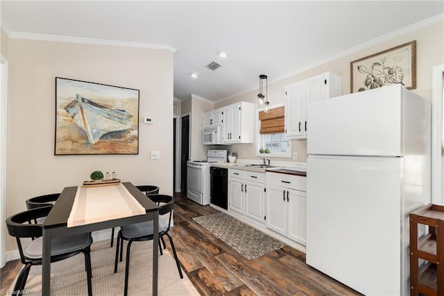 kitchen with white appliances, dark wood finished floors, crown molding, white cabinets, and recessed lighting