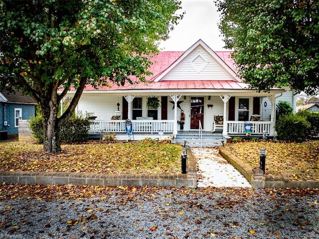 farmhouse-style home with central air condition unit and covered porch